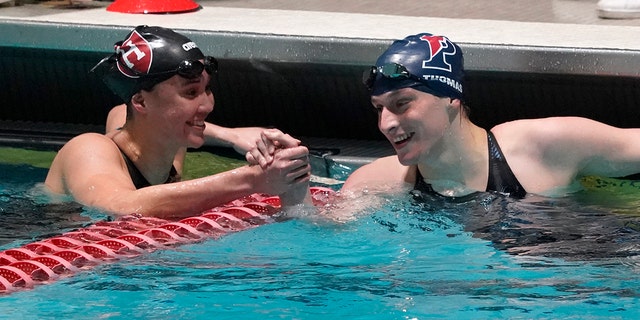 Leah Thomas, of Penn State, right, congratulates Samantha Shelton of Harvard University after Thomas set a record in the 200-yard freestyle final at the Ivy League Women's Swimming and Diving Championships Friday, February 18, 2022, in Cambridge, Massachusetts.
