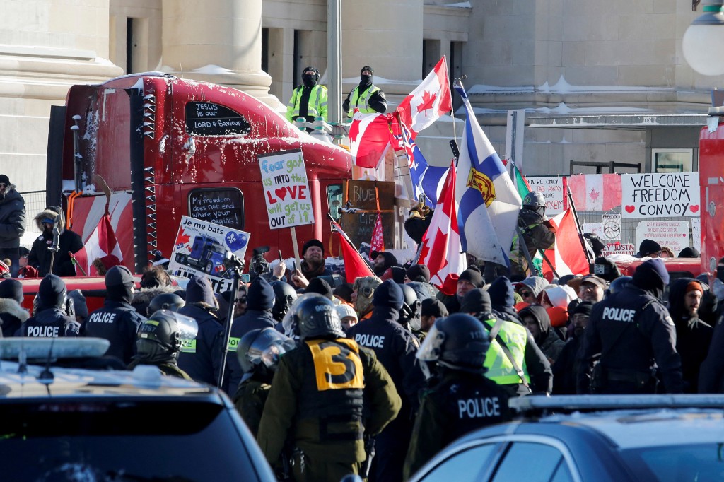 People are kept behind a police line as truck drivers and their supporters continue to protest mandates for a coronavirus (COVID-19) vaccine in Ottawa, Ontario, Canada, February 18, 2022. 
