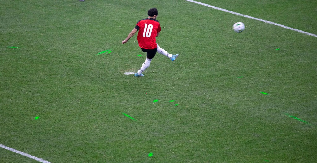 The light can be seen from the green laser pointers on the pitch when Mohamed Salah kicks the ball during a penalty shootout