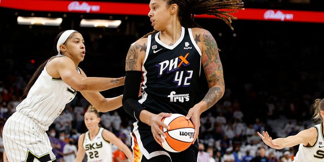 Phoenix Mercury Center Brittney Griner looks to pass as Candace Parker defends the Chicago Sky Center during the WNBA Basketball Finals on October 10, 2021 in Phoenix.