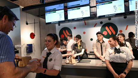 An employee gives a customer his food order in Vkusno & amp;  Restaurant Tochka in Moscow, after the opening ceremony.