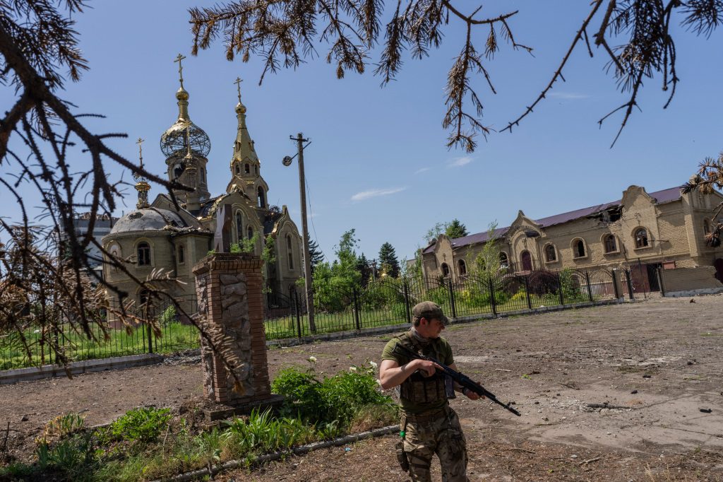A Ukrainian soldier patrols a village near the front line in Donetsk region, eastern Ukraine.