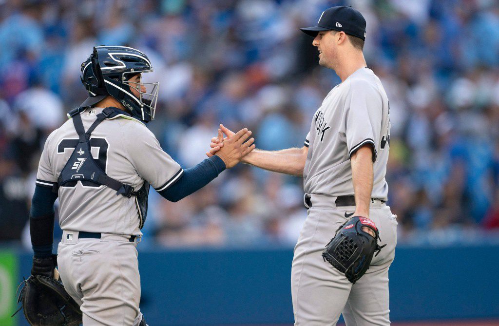 Clay Holmes and Jose Trevino celebrate after the Yankees' 4-0 win over the Blue Jays.