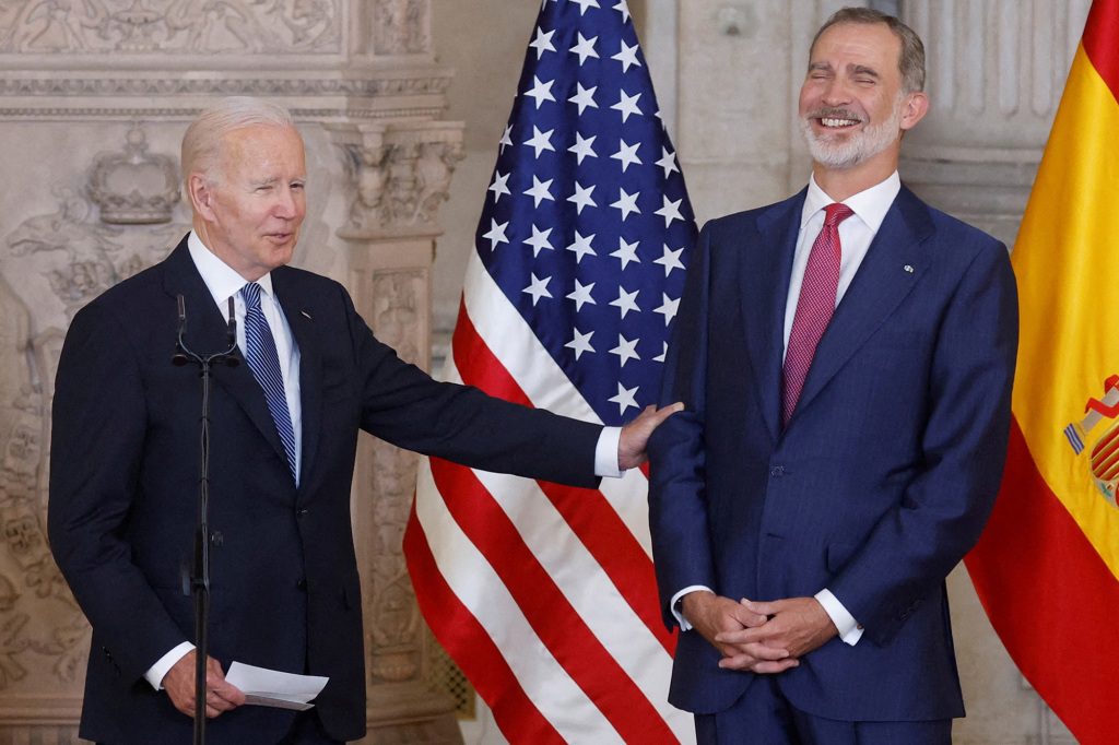 Spain's King Felipe VI laughs at an obvious joke from President Joe Biden.