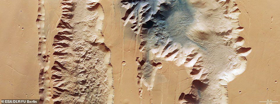 The huge valley of the red planet has been revealed in new images released by the European Space Agency.  The new image depicts two trenches, or chasma, that form part of the western part of Valles Marineris.  On the left is Lus Chasma which is 521 miles long and on the right is the Tithonium Chasma which is 500 miles long