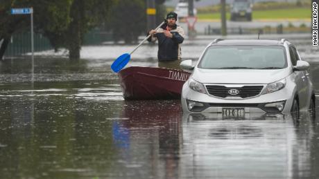 A man rows his boat on a flooded street in Windsor on the outskirts of Sydney, Australia, July 5, 2022.