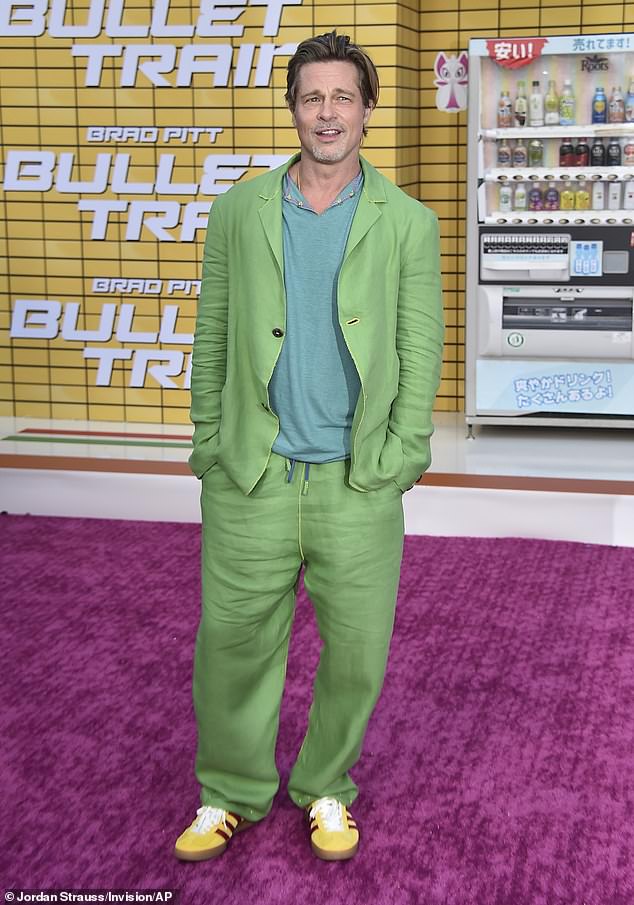 Brad's look: Pitt stepped out in a teal knit shirt under a light lime green coat with matching baggy pants