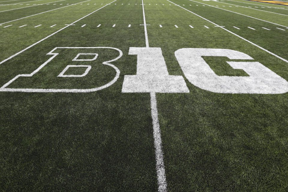 FILE - The Big Ten logo is displayed on the field before the NCAA college football game between Iowa and Miami, Ohio in Iowa City, Iowa, August 31, 2019. History and tradition?  Those terms carry no weight in what has essentially become a game of risk, as the Big Ten and Southeastern Conference take turns rolling dice to determine how to divide the world of college football.  (AP Photo/Charlie Neibergall, File)