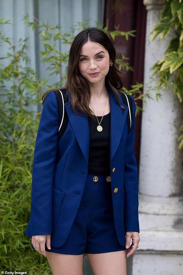 The Stylish Look: The stunning actress dazzled in a pair of navy pants and a matching jacket, while posing for photos at the promo for her Netflix movie.