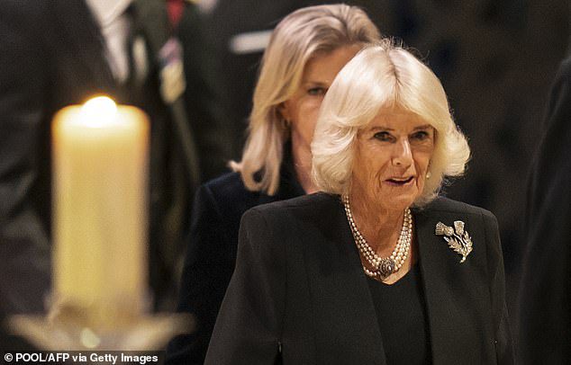 Camilla wears a black midi dress for a vigil, with a matching jacket, a large pearl necklace and a thorn brooch
