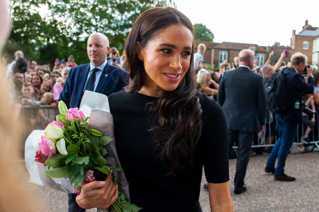 Markle's popularity remains low in the UK, but she has received a standing ovation from mourners outside Windsor Castle. 
