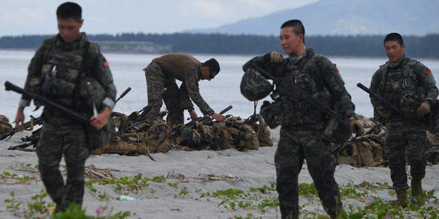 South Korea (foreground) and US Marines participate in a joint amphibious landing exercise with their Filipino counterparts on a beach facing the South China Sea in San Antonio, Zambales Province, October 7, 2022. 
