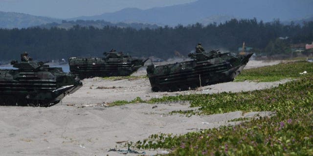 Philippine amphibious assault vehicles roll during a joint amphibious landing exercise with the US Marines on a beach overlooking the South China Sea in San Antonio, Zambales, October 7, 2022.
