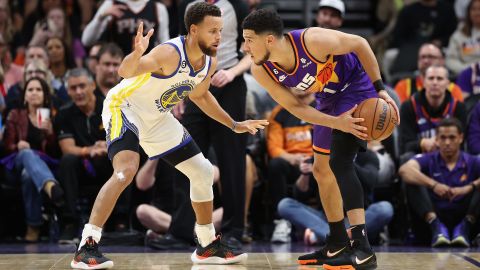 Booker deals the ball against Curry during the first half of a game in Phoenix on October 25.