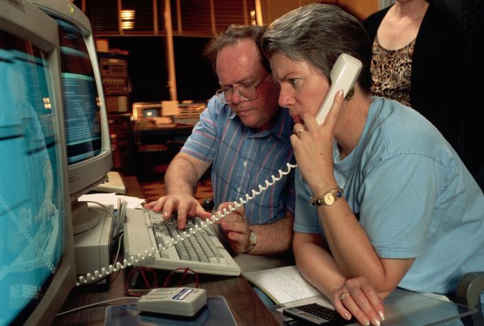 Astronomers Larry Webster and Jill Tarter watch computer screens at the observatory on October 10, 1992. They work to begin the search for signs of extraterrestrial life.