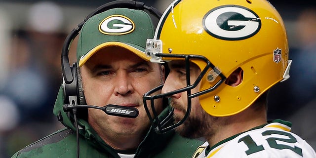 Green Bay Packers coach Mike McCarthy talks with quarterback Aaron Rodgers (12) during the first half of an NFC Championship game against the Seattle Seahawks in Seattle Jan. 18, 2015. 