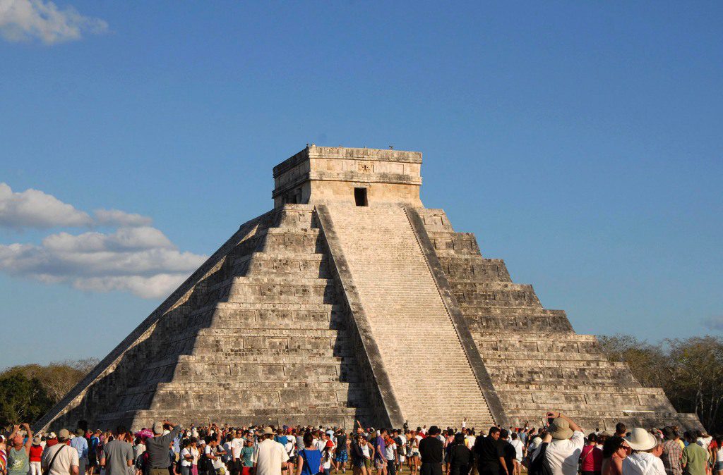 Tourists gather under the pyramid of Chichen Itza in Merida
