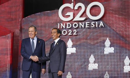 Russian Foreign Minister Sergey Lavrov greets Indonesian President Joko Widodo as he arrives for the G20 Leaders' Summit in Bali.