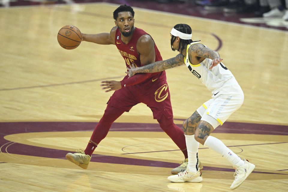 December 19, 2022;  Cleveland, Ohio, USA;  Utah Jazz guard Jordan Clarkson (00) defends against Cleveland Cavaliers guard Donovan Mitchell (45) in the first quarter at Rocket Mortgage FieldHouse.  Mandatory credit: David Richard - USA TODAY Sports